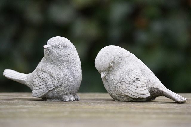 Two plaster birds – one rejecting the other