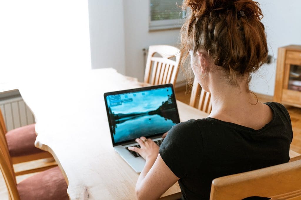 Woman with laptop in home office